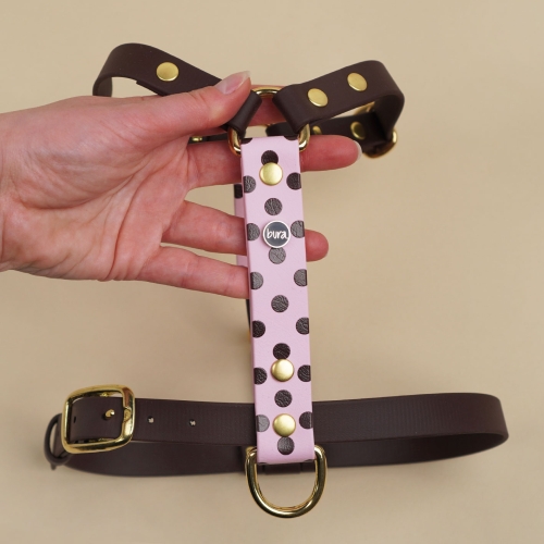 Szelki guard z Biothane dla psa, pudrowy róż w brązowe kropki, trzymane w dłoni – widok z przodu.